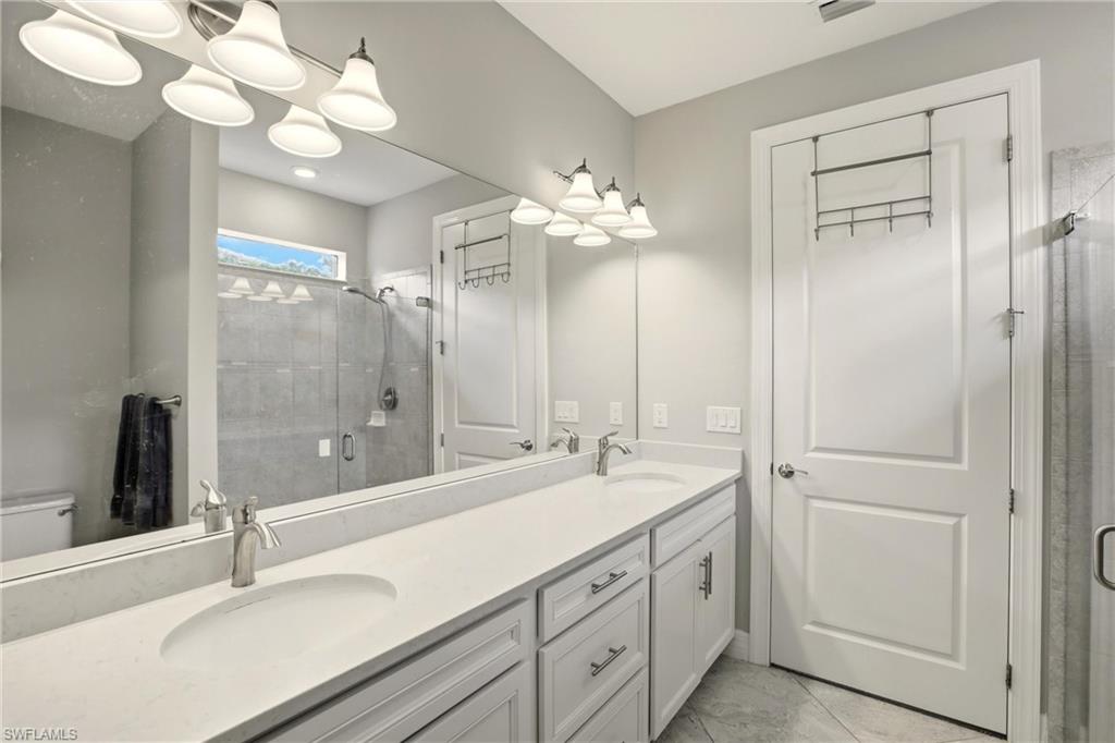 11216 Carlingford Road Fort Myers, FL 33913 - Photo 24 of 38 a bathroom with a double vanity sink mirror and double