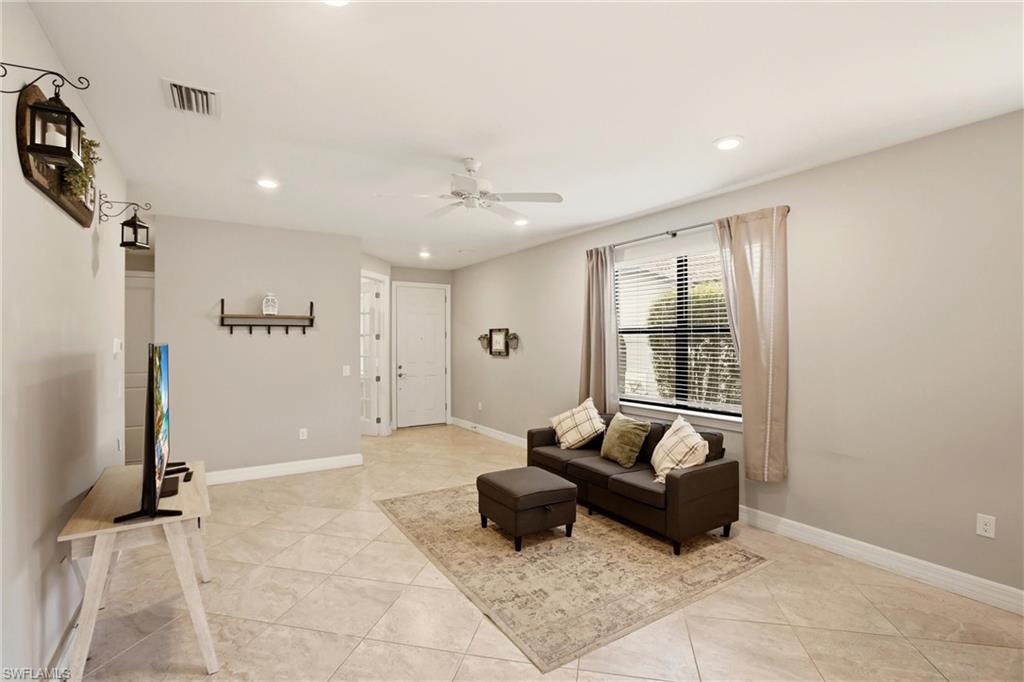 11216 Carlingford Road Fort Myers, FL 33913 - Photo 9 of 38 a living room with furniture and a flat screen tv