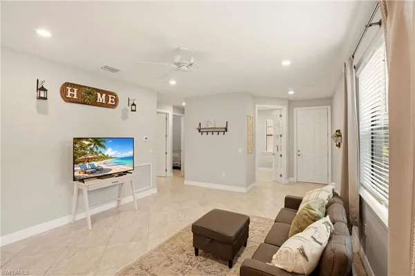 a kitchen with a refrigerator a sink dishwasher a stove and white cabinets