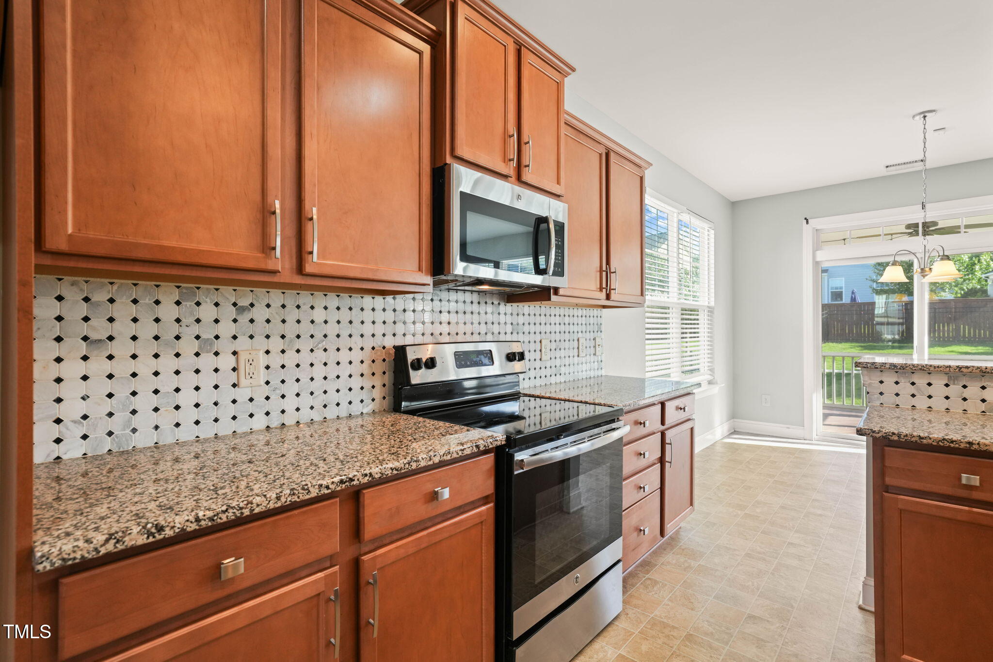 4508 Brintons Cottage Street Raleigh, NC 27616 - Photo 8 of 46 a kitchen with stainless steel appliances granite countertop a stove a sink and a microwave