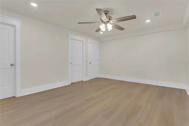 a bathroom with a granite countertop sink a toilet and shower