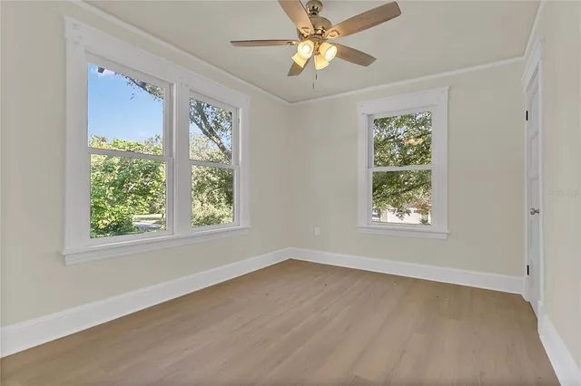 wooden floor in an empty room with a window