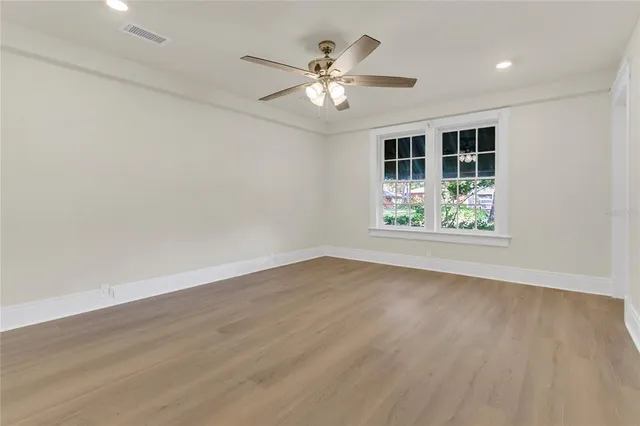 a bathroom with a granite countertop sink a toilet and a mirror