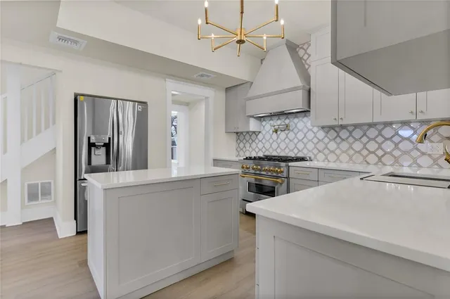 a kitchen with a sink stove and refrigerator