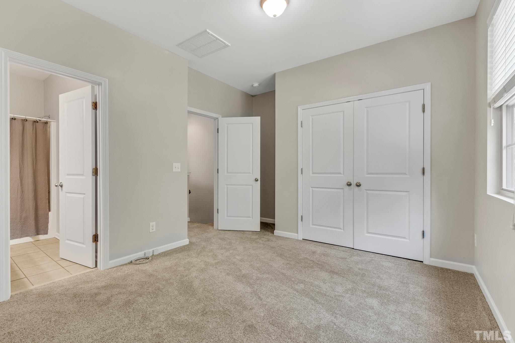 762 Wickham Ridge Road Apex, NC 27539 - Photo 16 of 32 a view of an empty room and closet area