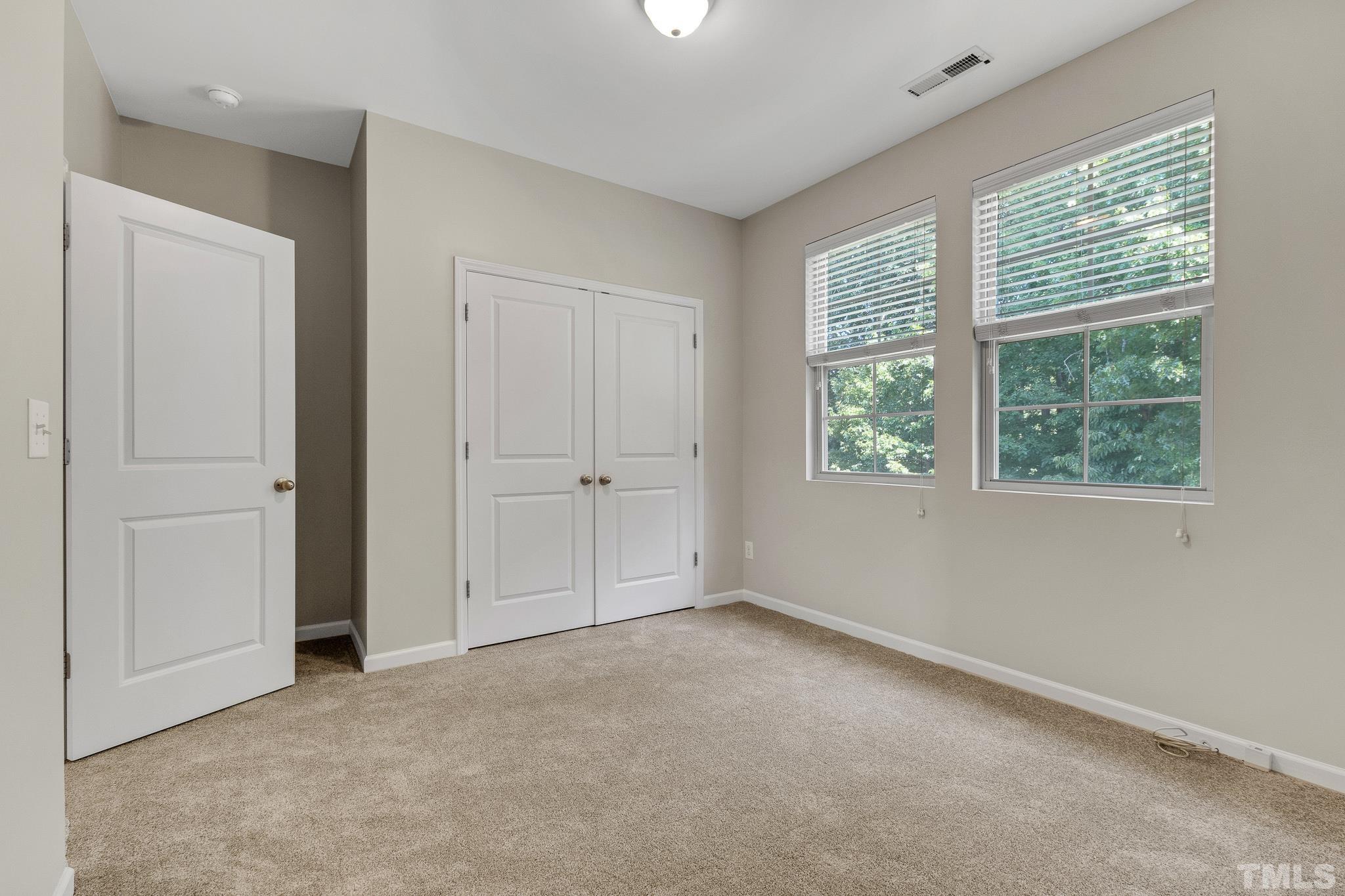 762 Wickham Ridge Road Apex, NC 27539 - Photo 19 of 32 an empty room with windows
