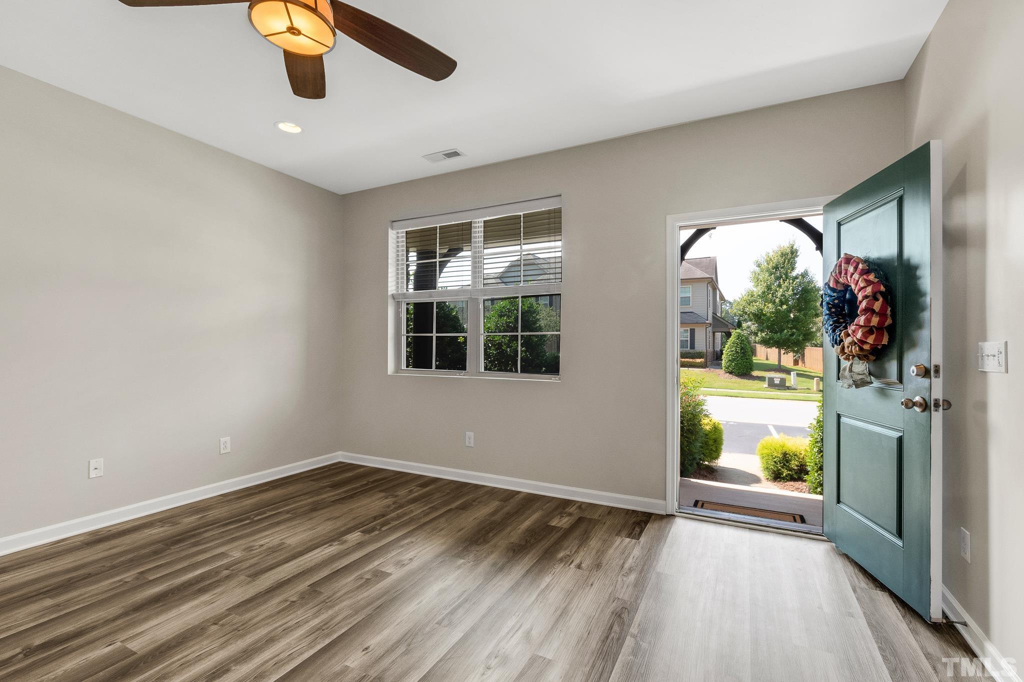 762 Wickham Ridge Road Apex, NC 27539 - Photo 3 of 32 wooden floor in an empty room with a window