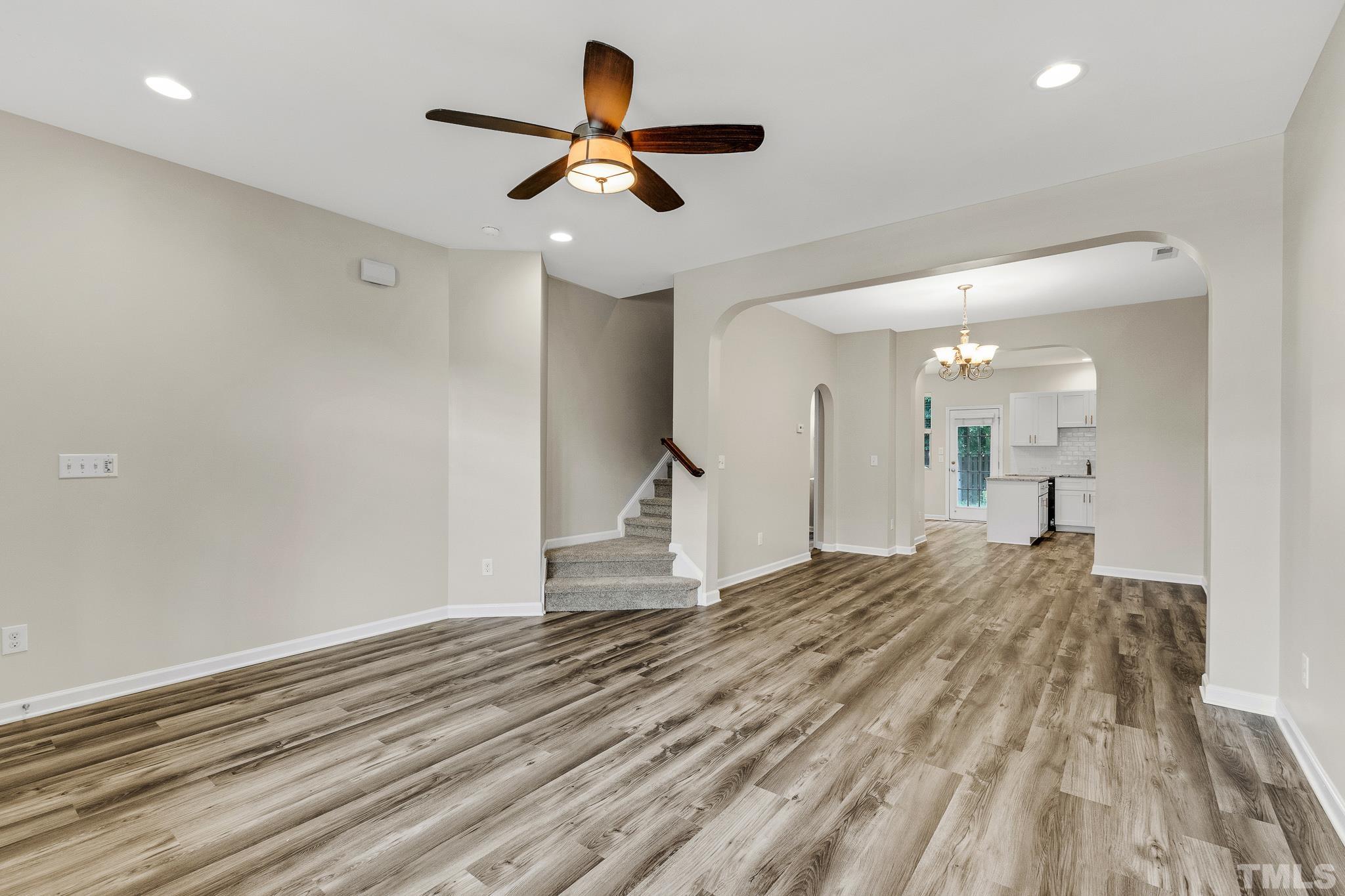 762 Wickham Ridge Road Apex, NC 27539 - Photo 5 of 32 a view of a livingroom with a ceiling fan