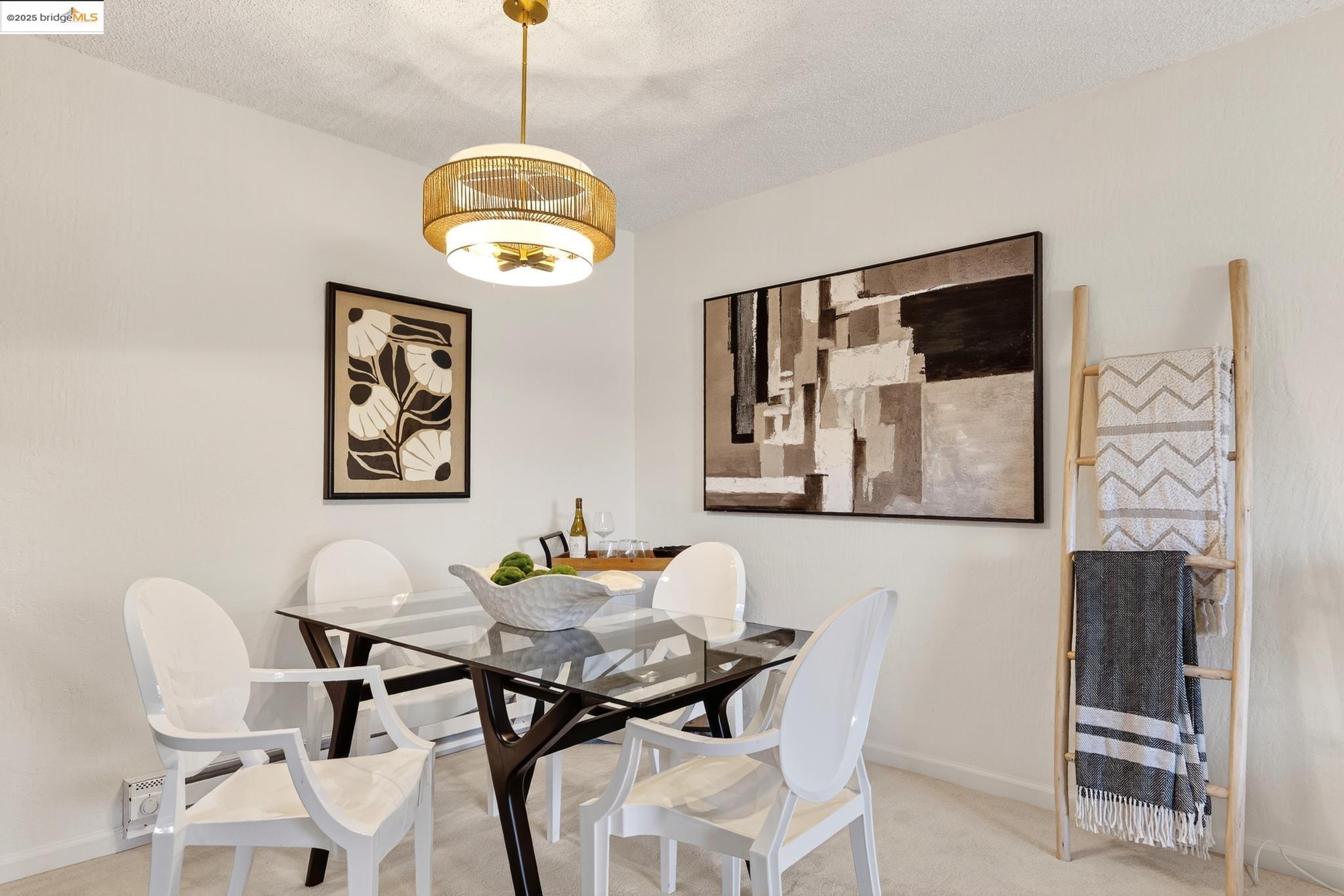 1311 Webster Street, Unit E316 Alameda, CA 94501 - Photo 11 of 39 a view of a dining room with furniture and chandelier
