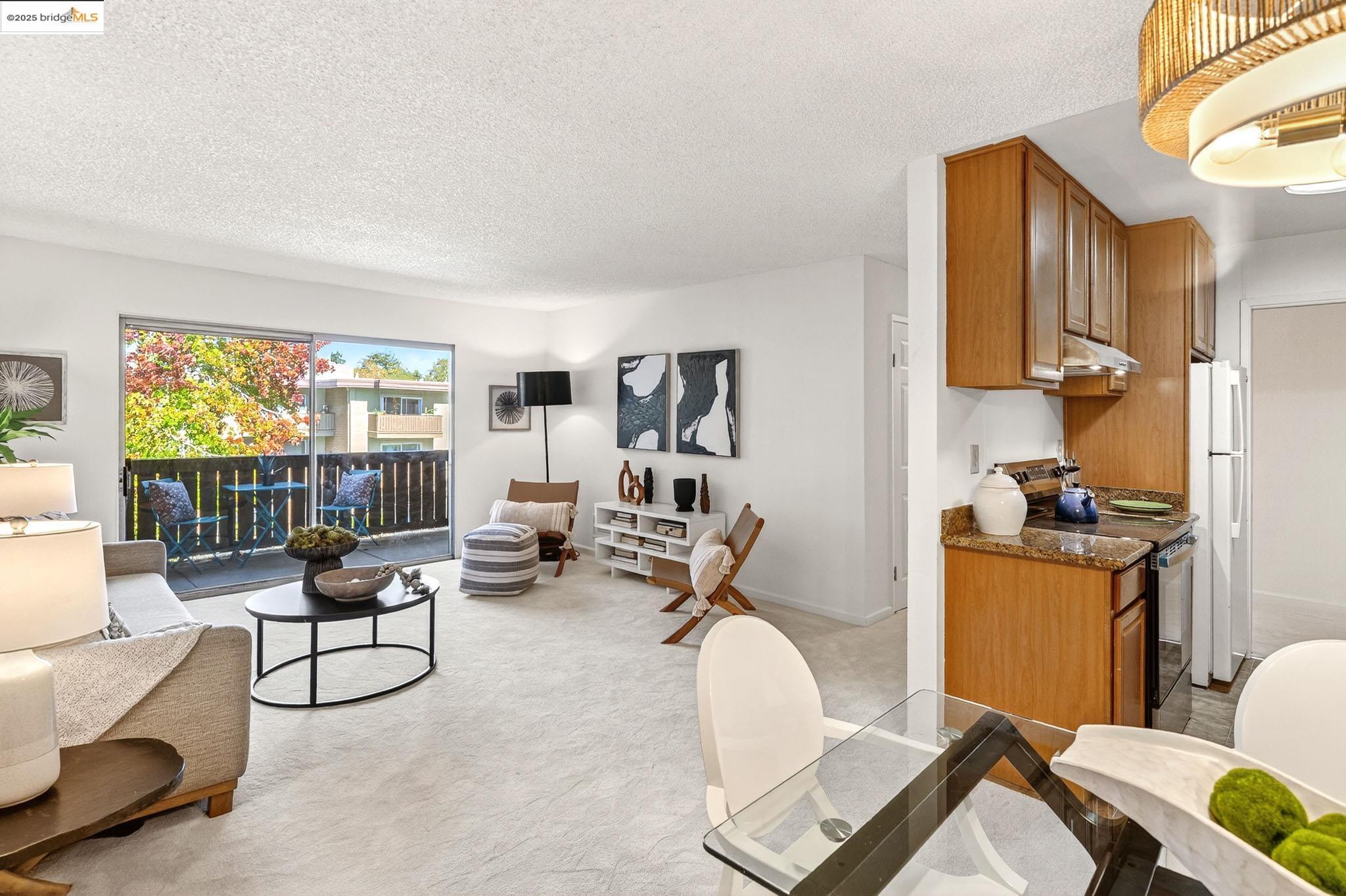 1311 Webster Street, Unit E316 Alameda, CA 94501 - Photo 12 of 39 a living room with furniture and a window