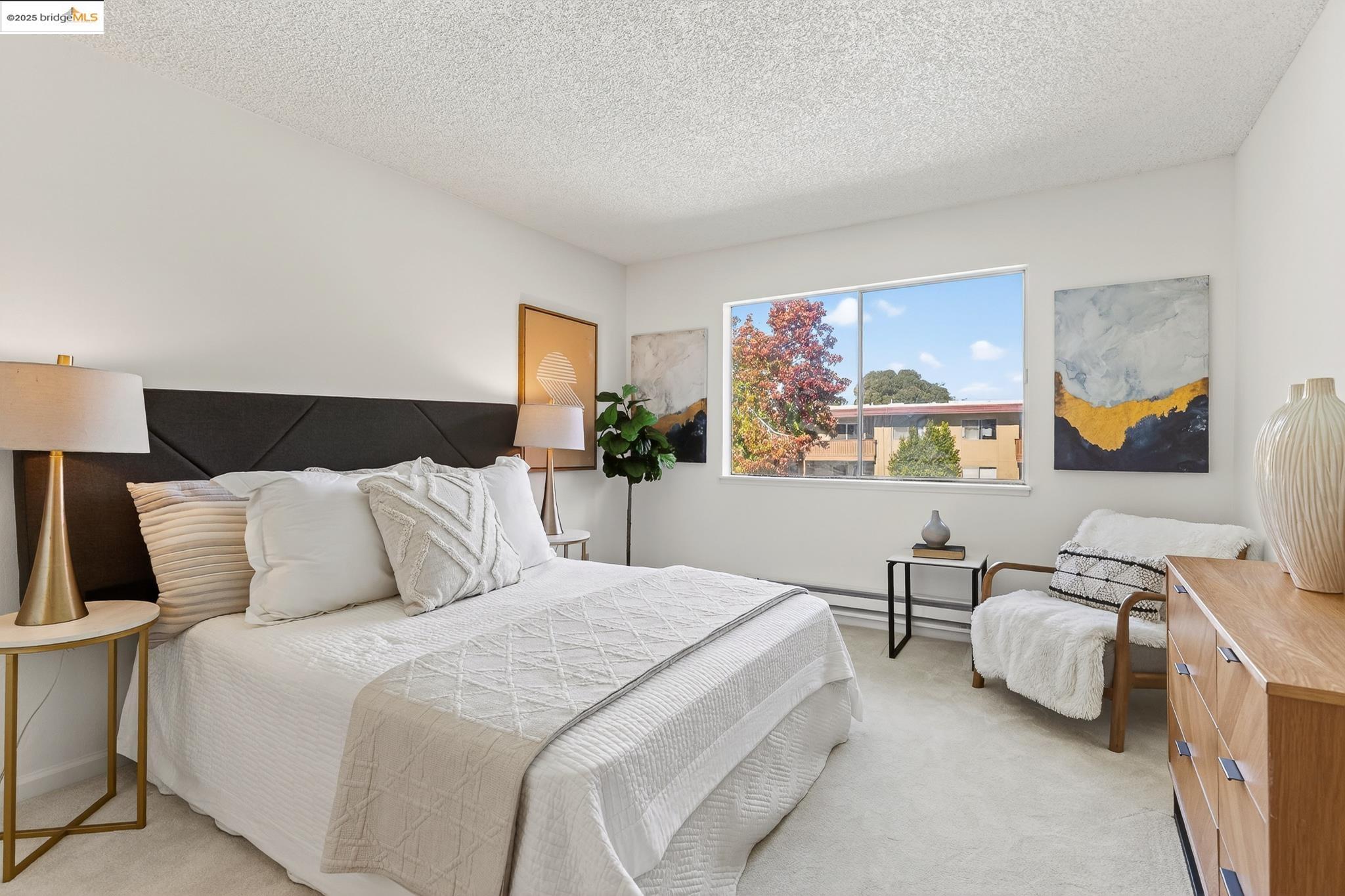 1311 Webster Street, Unit E316 Alameda, CA 94501 - Photo 19 of 39 a bedroom with a bed couch and window