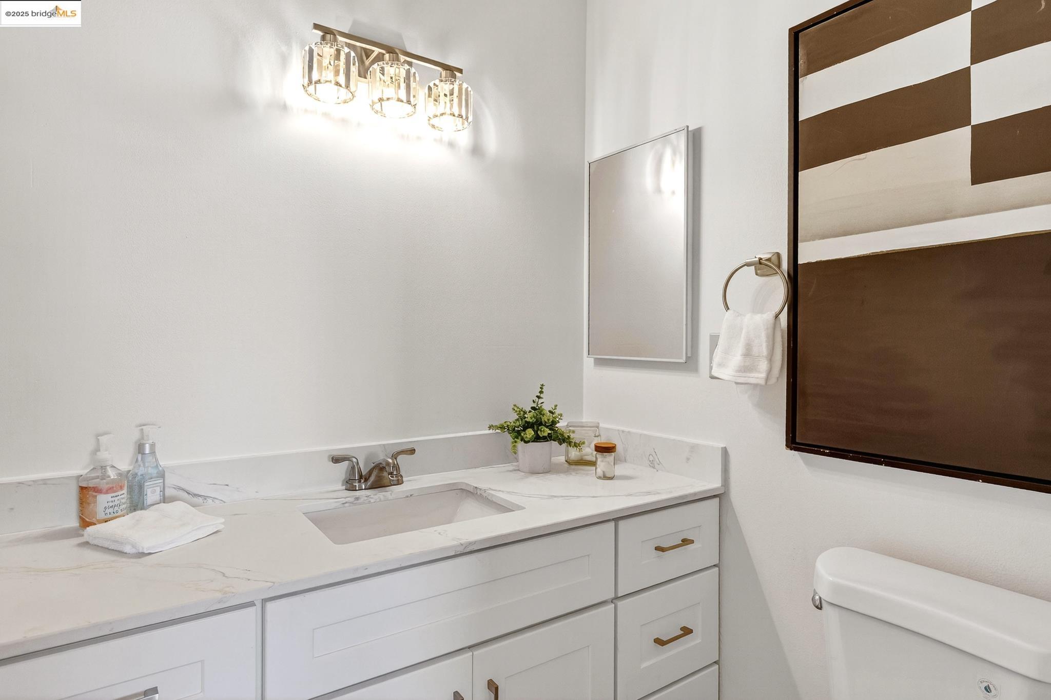 1311 Webster Street, Unit E316 Alameda, CA 94501 - Photo 23 of 39 a bathroom with a sink and a mirror