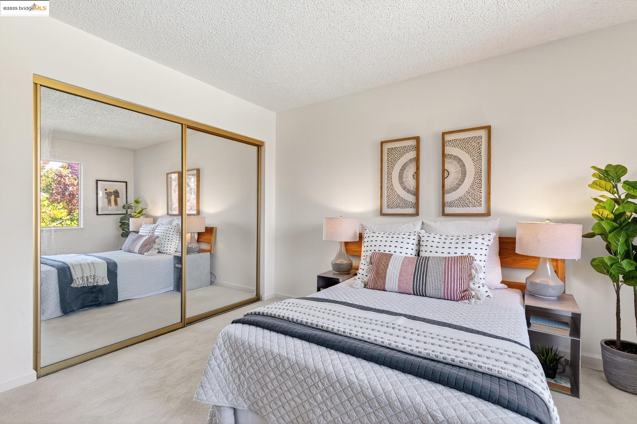 1311 Webster Street, Unit E316 Alameda, CA 94501 - Photo 25 of 39 a bedroom with furniture and a mirror