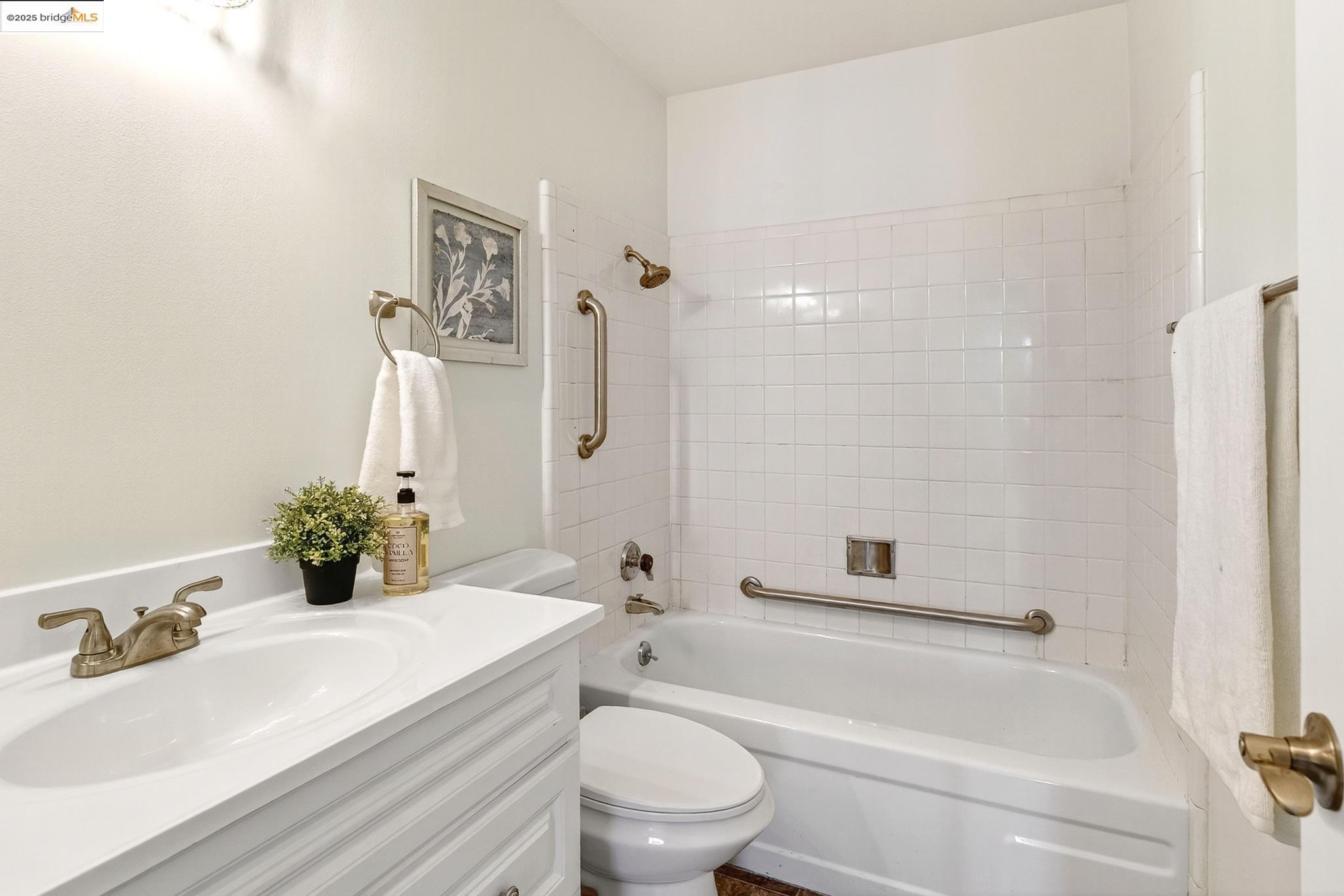 1311 Webster Street, Unit E316 Alameda, CA 94501 - Photo 26 of 39 a bathroom with a sink toilet and shower