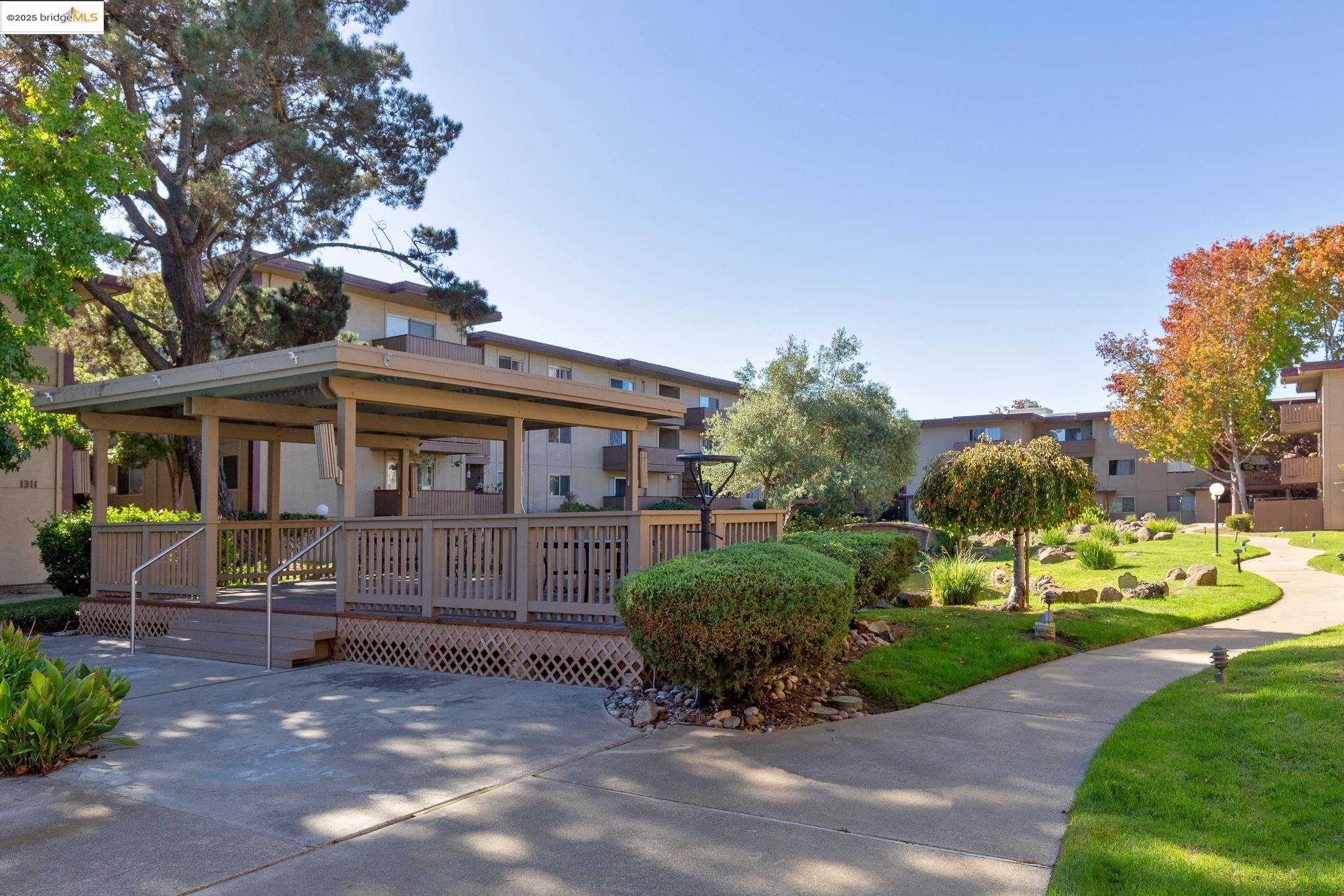 1311 Webster Street, Unit E316 Alameda, CA 94501 - Photo 29 of 39 a front view of a house with garden