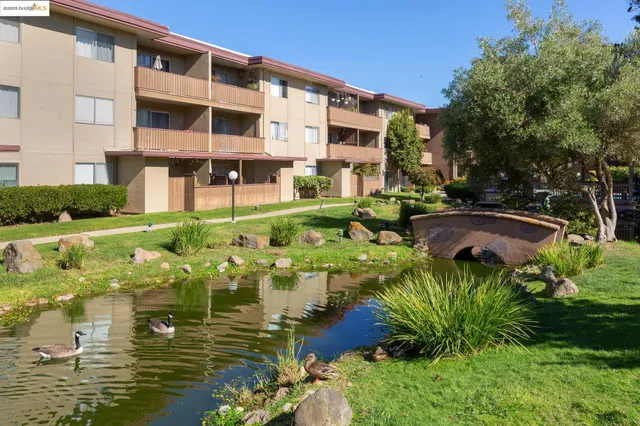 a balcony with couple of cars parked in front of it