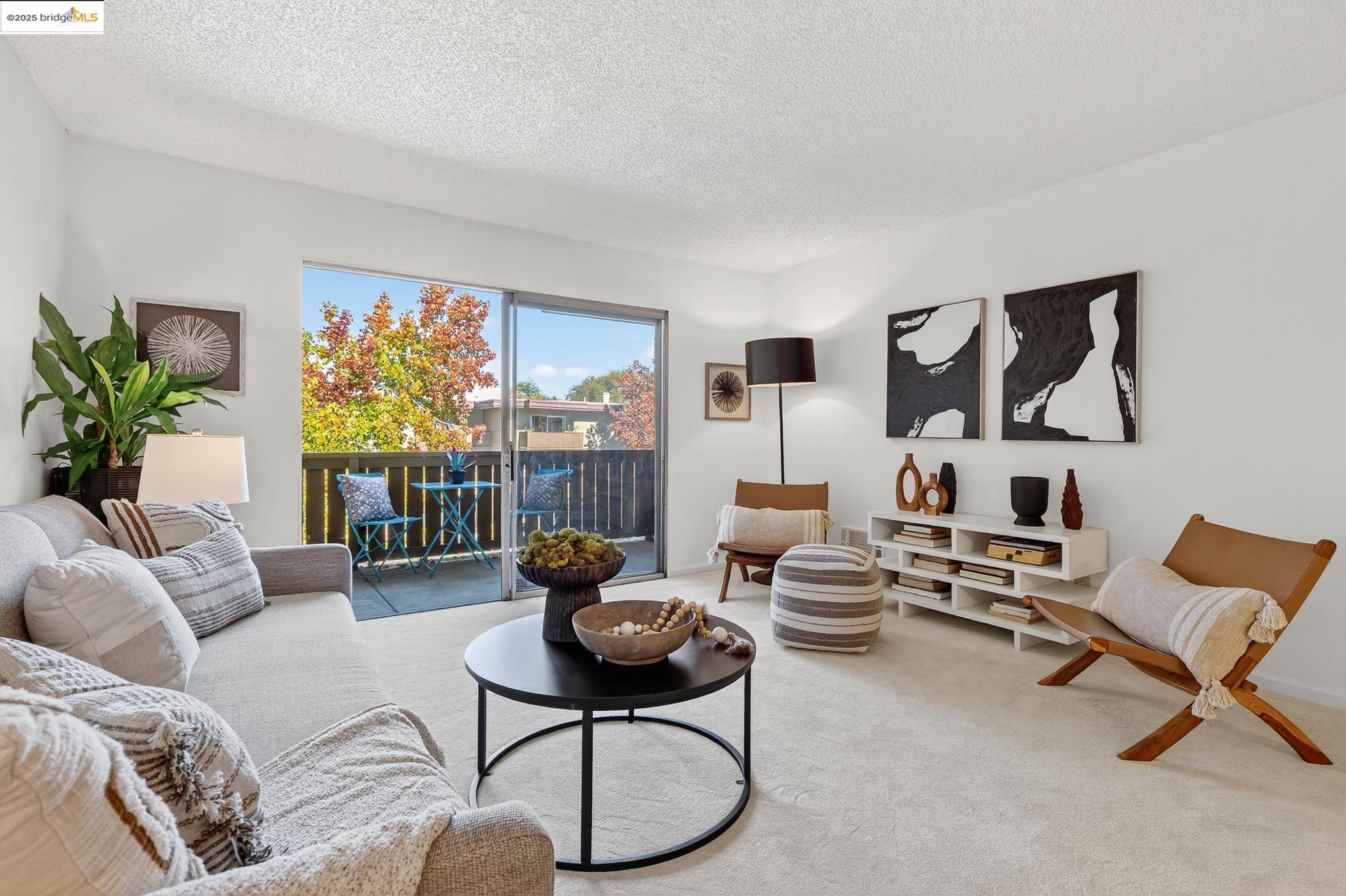 1311 Webster Street, Unit E316 Alameda, CA 94501 - Photo 5 of 39 a living room with furniture and a floor to ceiling window