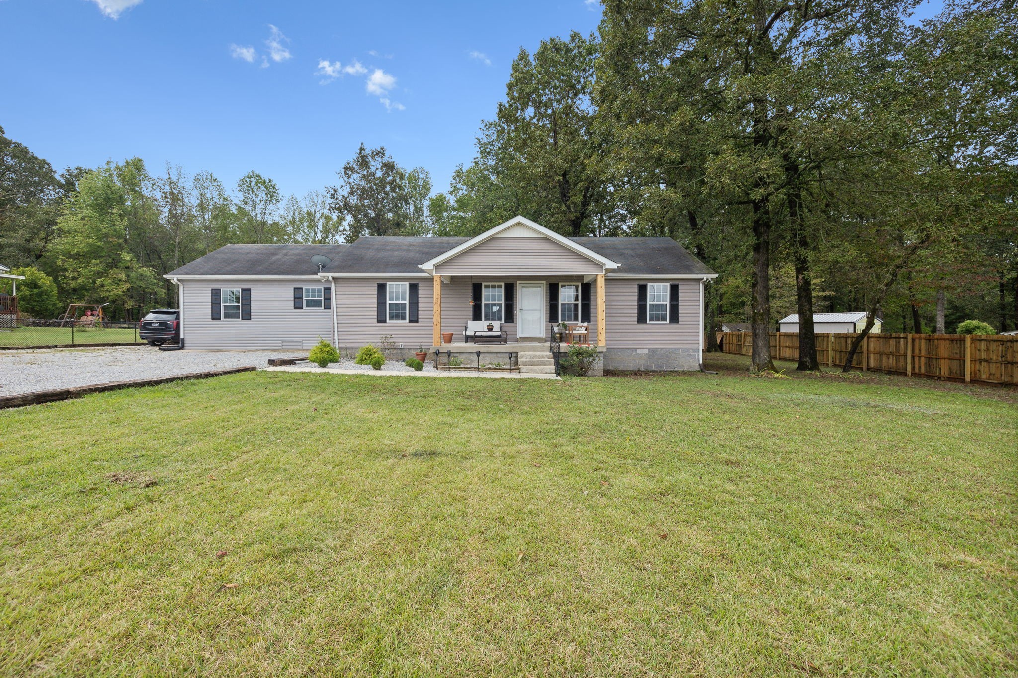 261 Tom Johnson Road Morrison, TN 37357 - Photo 12 of 40 a front view of a house with a garden and trees