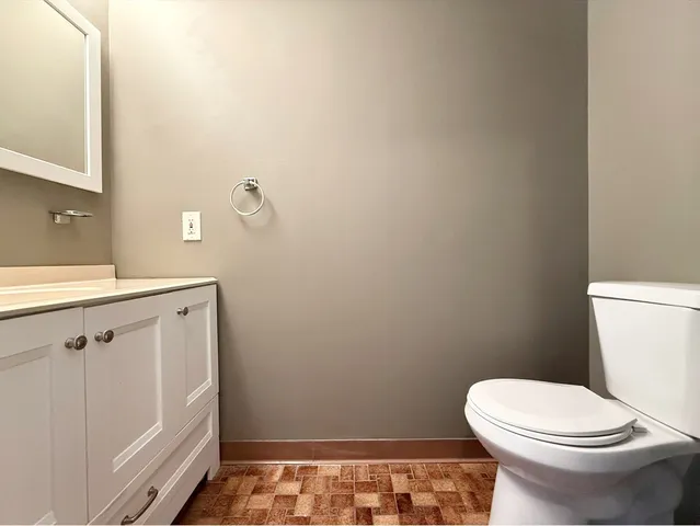 a bathroom with a sink a toilet and vanity