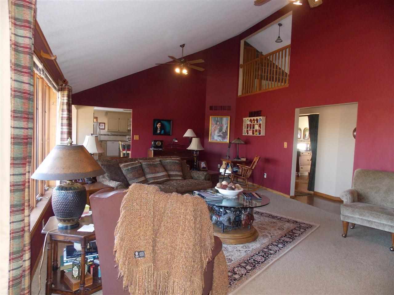 15228 East McNeal Road Monroe Center, IL 61052 - Photo 12 of 25 a living room with furniture a large window and potted plant