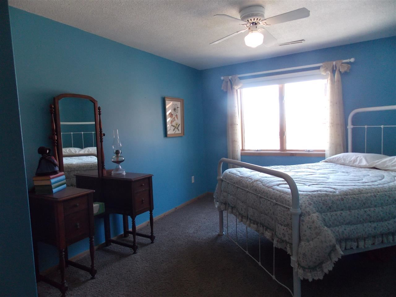 15228 East McNeal Road Monroe Center, IL 61052 - Photo 15 of 25 a bedroom with a bed table chair and a window