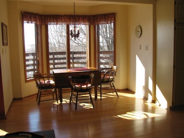 15228 East McNeal Road Monroe Center, IL 61052 - Photo 7 of 25 a view of a dining room with furniture window and wooden floor