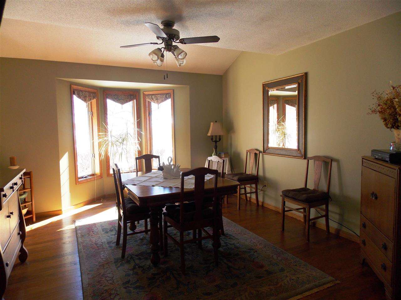 15228 East McNeal Road Monroe Center, IL 61052 - Photo 8 of 25 a view of a dining room with furniture window and wooden floor