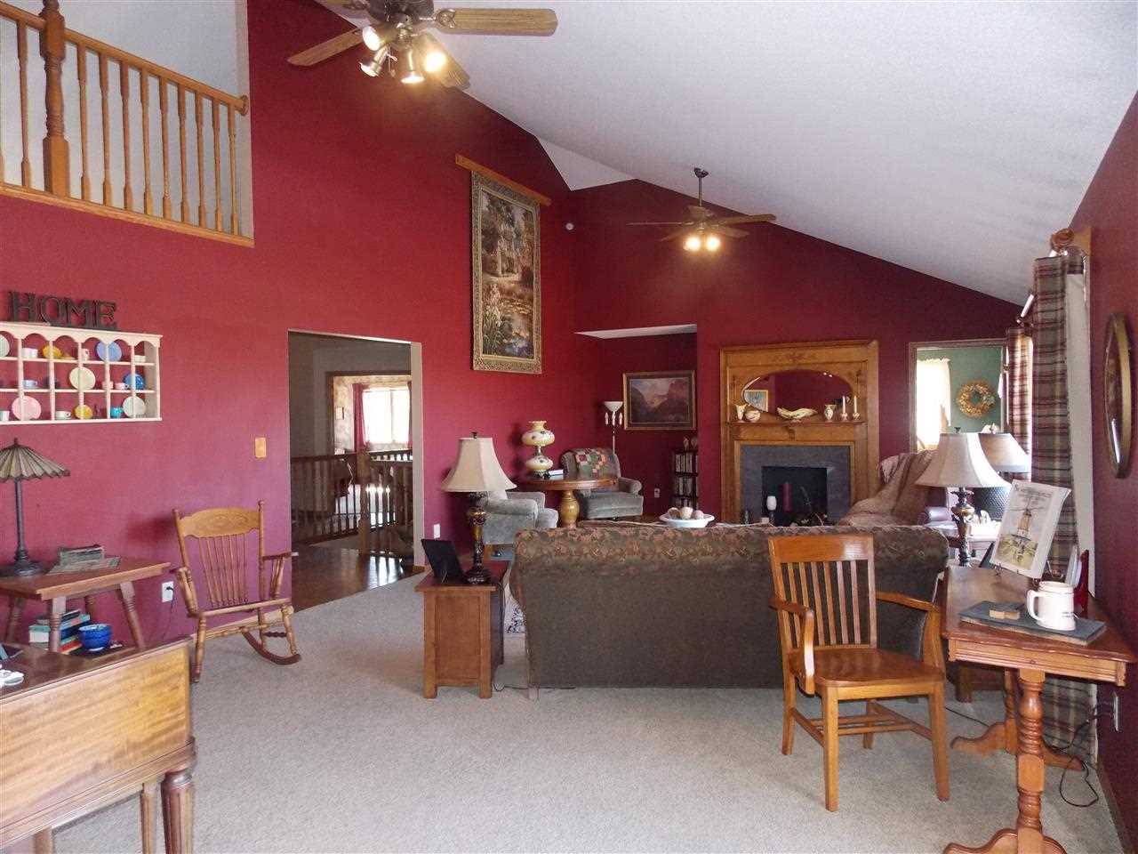 15228 East McNeal Road Monroe Center, IL 61052 - Photo 9 of 25 a living room with furniture and a chandelier