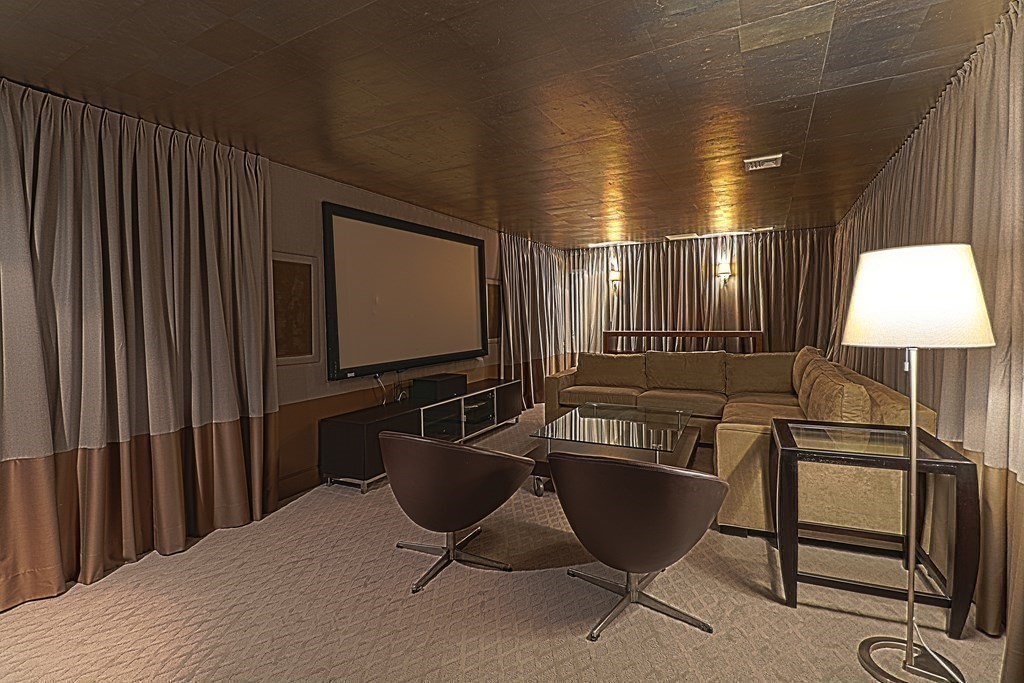 6 Sutton Place Acton, MA 01720 - Photo 17 of 24 a living room with a couch and a flat screen tv