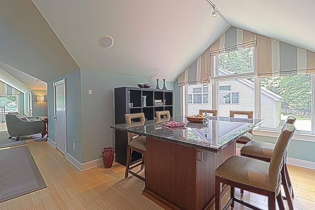 6 Sutton Place Acton, MA 01720 - Photo 18 of 24 a dining room with a table chairs and flat screen tv