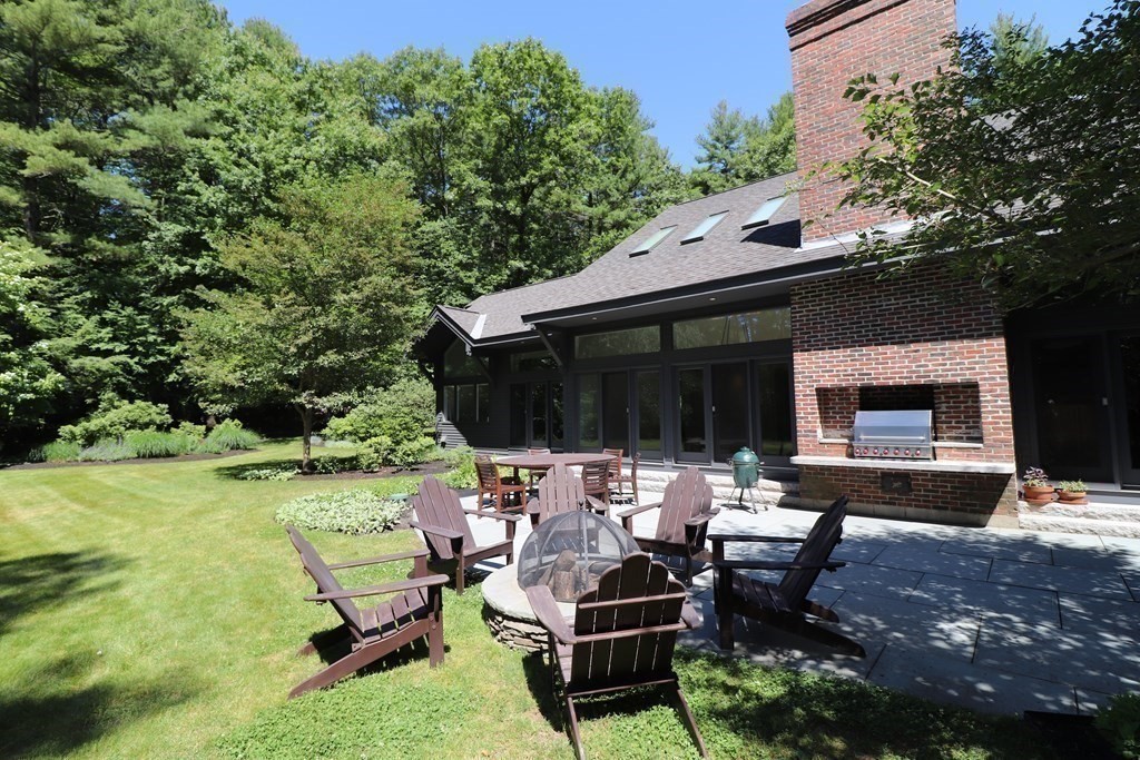 6 Sutton Place Acton, MA 01720 - Photo 21 of 24 a backyard of a house with table and chairs