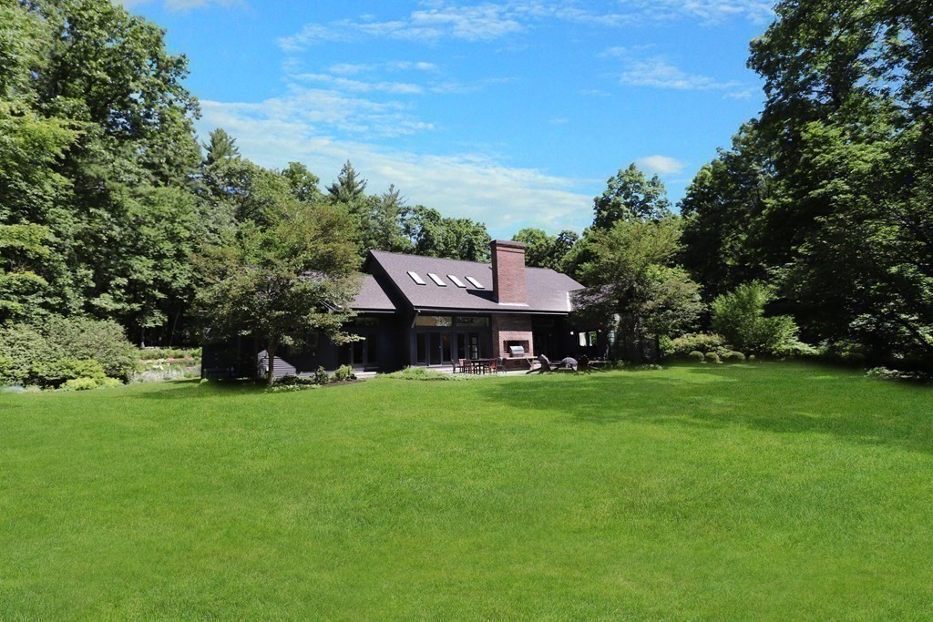 6 Sutton Place Acton, MA 01720 - Photo 22 of 24 a view of a house with a big yard potted plants and large trees
