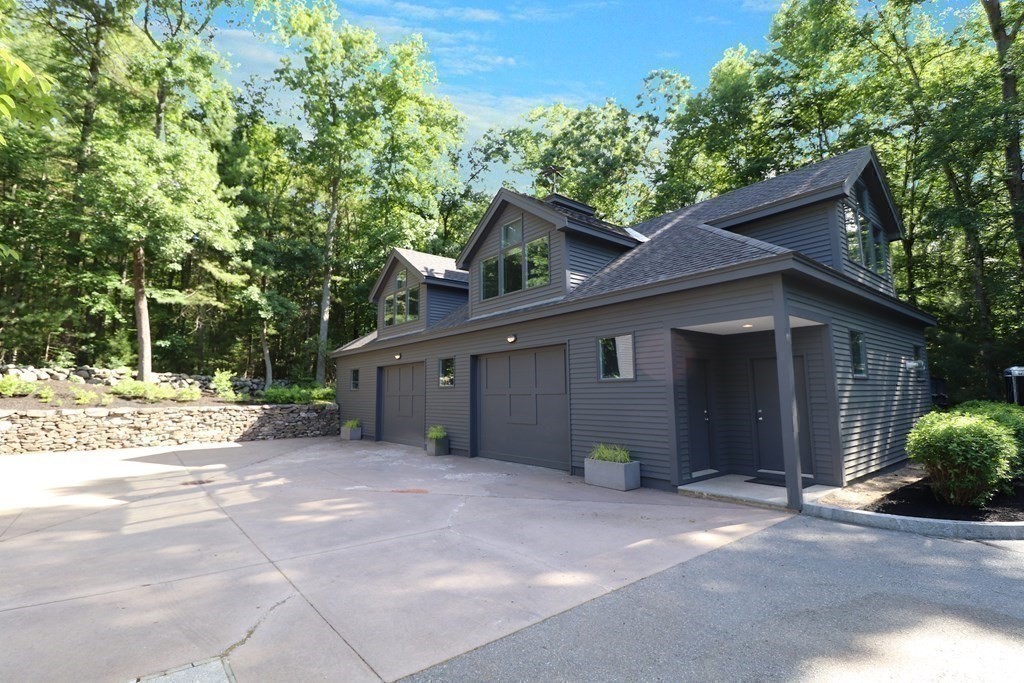 6 Sutton Place Acton, MA 01720 - Photo 23 of 24 a view of a barn house next to a yard with large trees