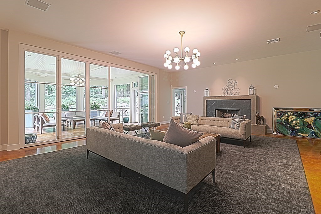 6 Sutton Place Acton, MA 01720 - Photo 8 of 24 a living room with furniture and a chandelier