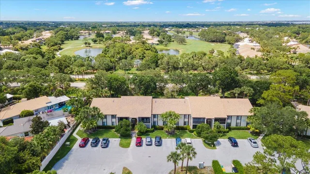 an aerial view of residential house with outdoor space and trees all around