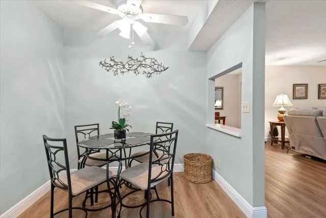a dining room with furniture and wooden floor
