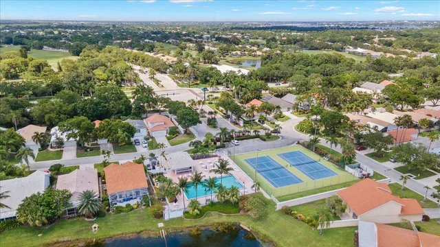 an aerial view of residential houses with outdoor space and river
