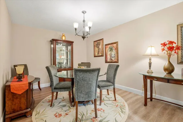 a view of a dining room with furniture and chandelier