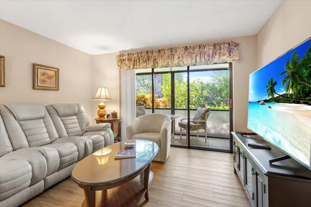 a living room with furniture fireplace and flat screen tv