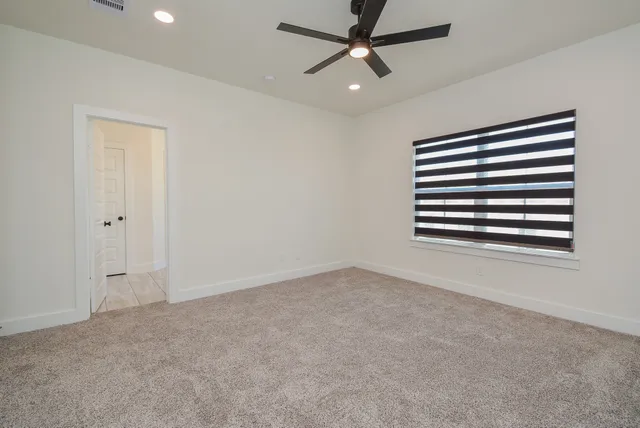 a spacious bathroom with a tub sink and mirror