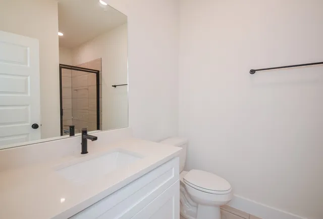 a bathroom with a glass shower door