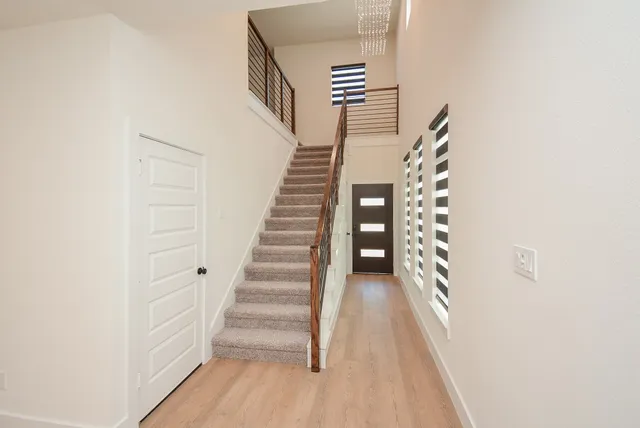 a view of entryway and hall with wooden floor