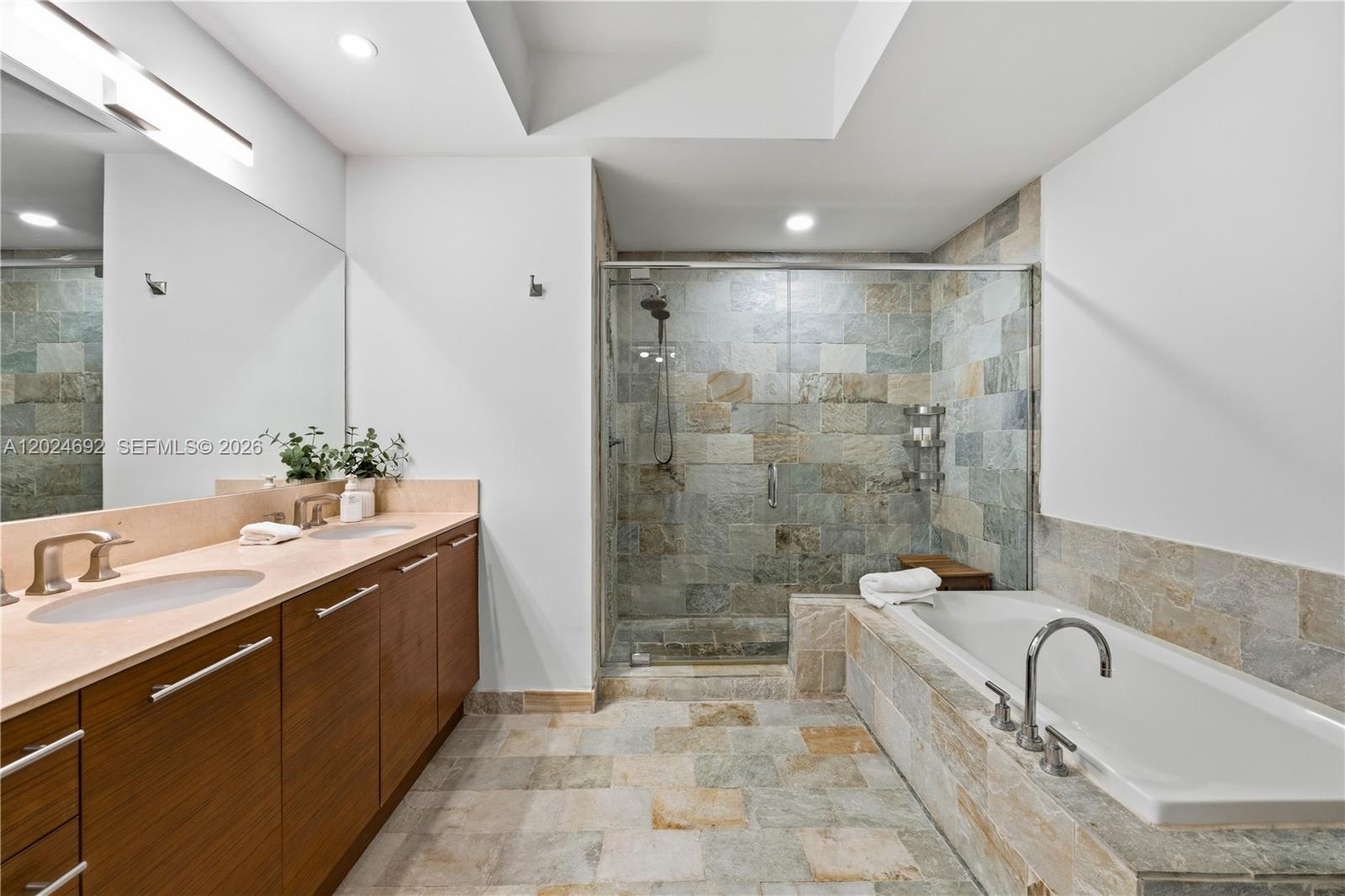 2641 North Flamingo Road, Unit 2605N Sunrise, FL 33323 - Photo 20 of 56 a bathroom with a tub sink shower and mirror