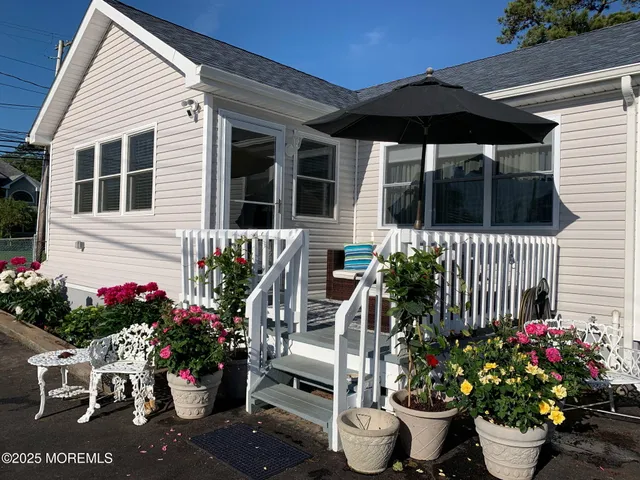 a front view of a house with a flower garden