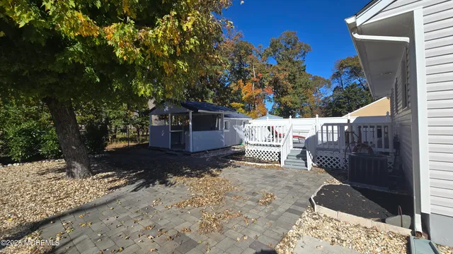 a backyard of a house with table and chairs