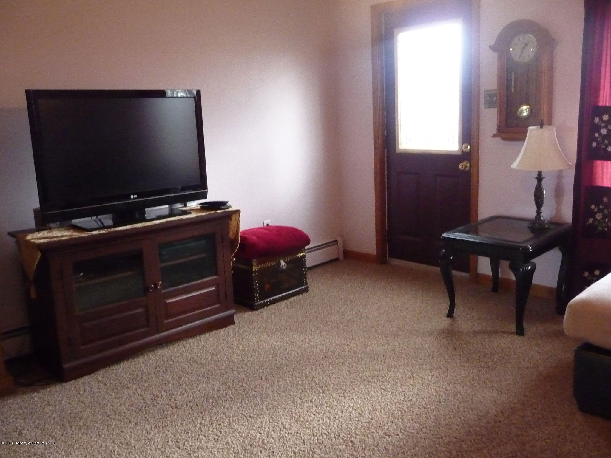 817 Coon Road Wyoming, PA 18644 - Photo 5 of 20 a living room with furniture and a flat screen tv