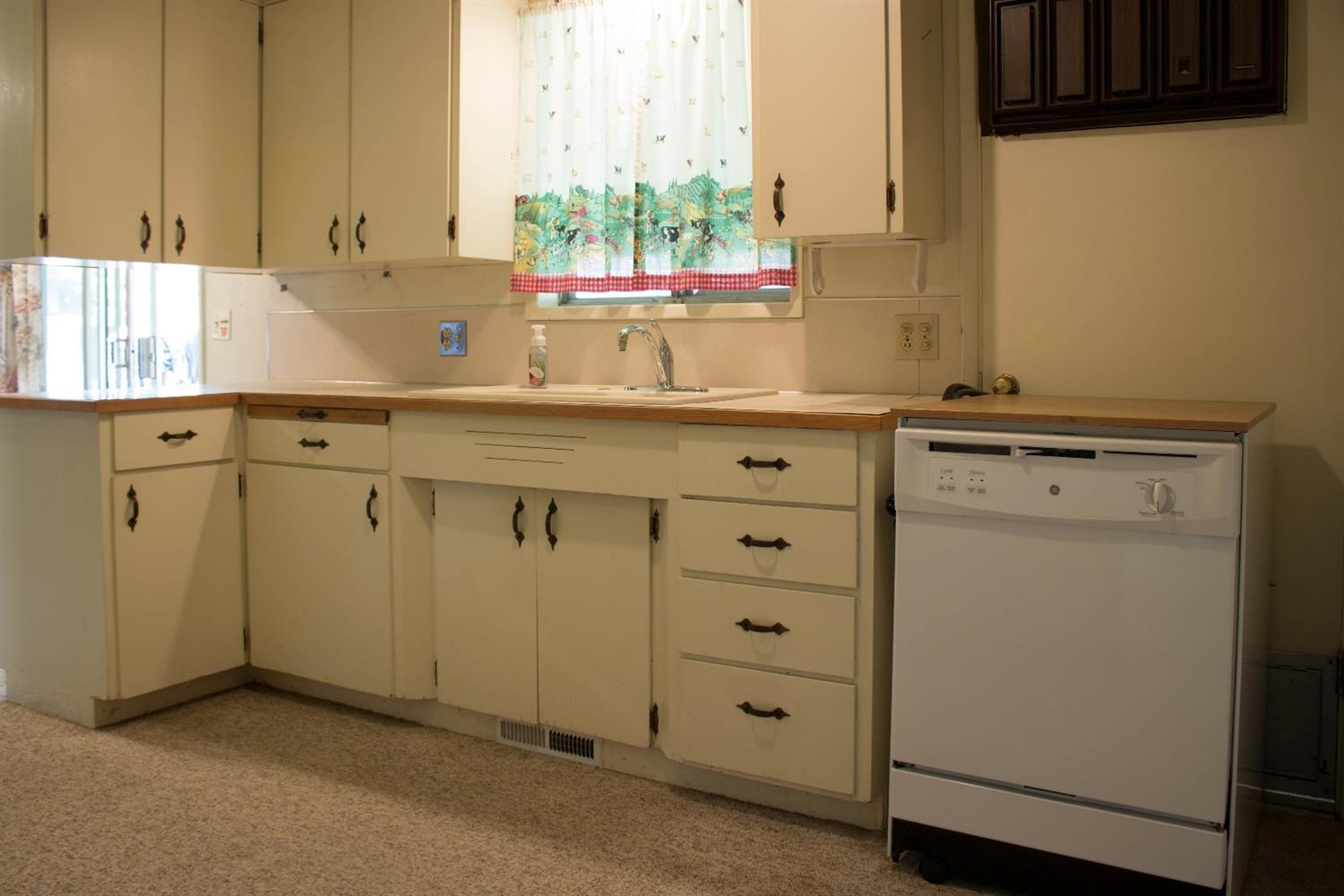 2613 Table Rock Road Medford, OR 97501 - Photo 7 of 23 a kitchen with granite countertop cabinets sink and window