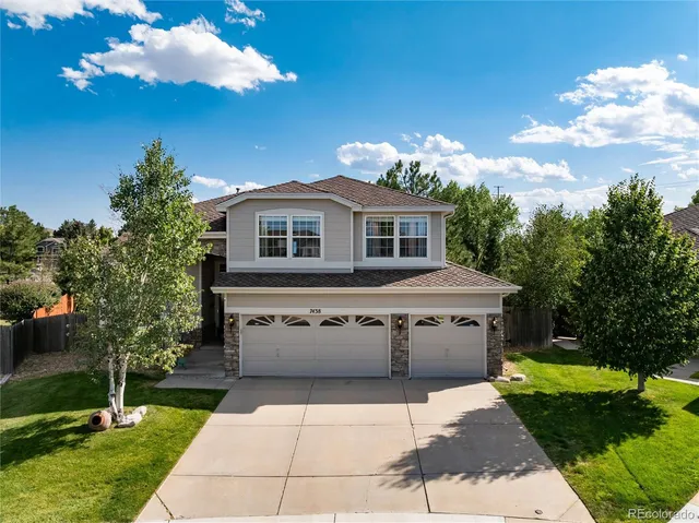 a front view of a house with a yard and outdoor seating