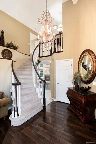 a view of a living room with furniture and wooden floor