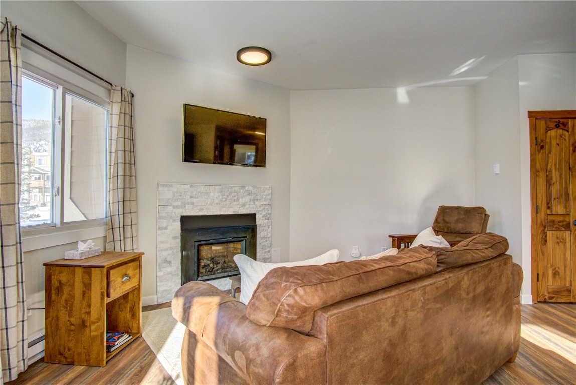 78 Summit Drive, Unit C11 Dillon, CO 80435 - Photo 11 of 21 a bedroom with a bed and a fireplace
